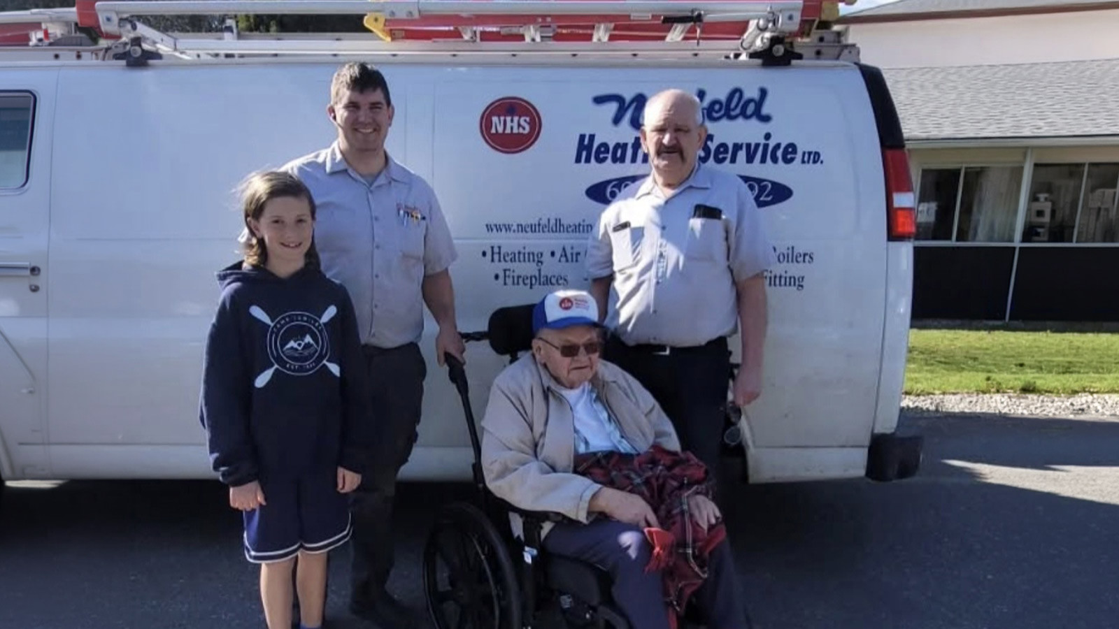The Neufeld Heating team standing in front of their service van for gas fireplace maintenance in Abbotsford.